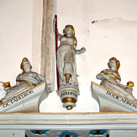 Pediment of wall monument with allegorical figures carrying geometrical symbols