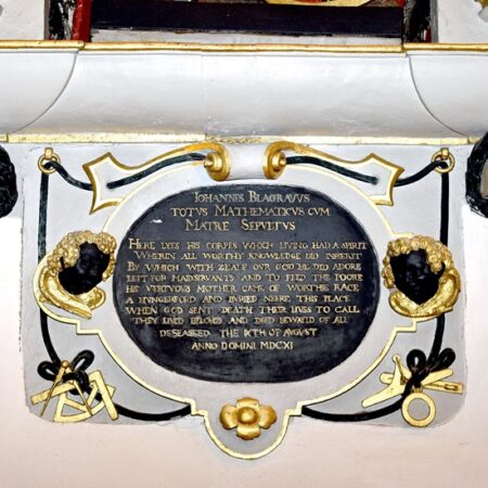 Antependium of wall monument with a plaque, suspended from a fictive rope looped through rings at each top corner, which is inscribed with an effusive eulogy. To either side are black-faced cherubs heads, whilst beneath in the bottom corners can be seen the mathematical instruments reflecting Blagrave’s scholarly interests. Either side of the plaque are skulls framed with blackened laurel wreaths.