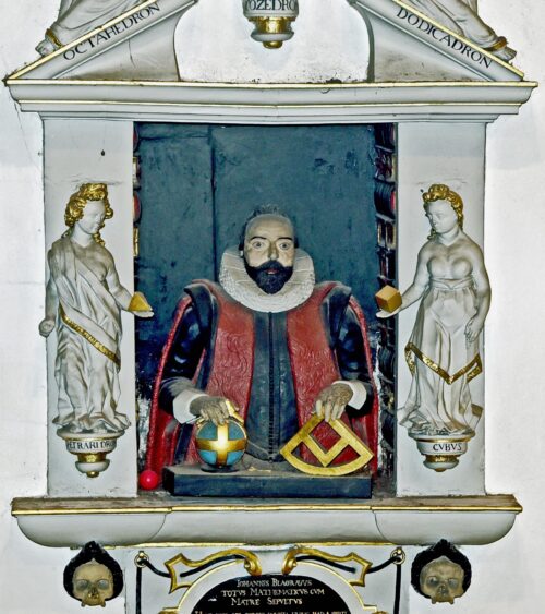 Wall monument: bearded man in lay costume holding mathematical instruments, set in a book-lined tabernacle, surrounded by allegorical figures that carry geometrical symbols. Wall monument: bearded man in lay costume holding mathematical instruments, set in a book-lined tabernacle, surrounded by allegorical figures that carry geometrical symbols.