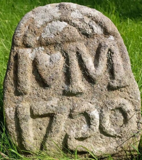 Granite headstone. Inscription IM 1729 in large raised letters.