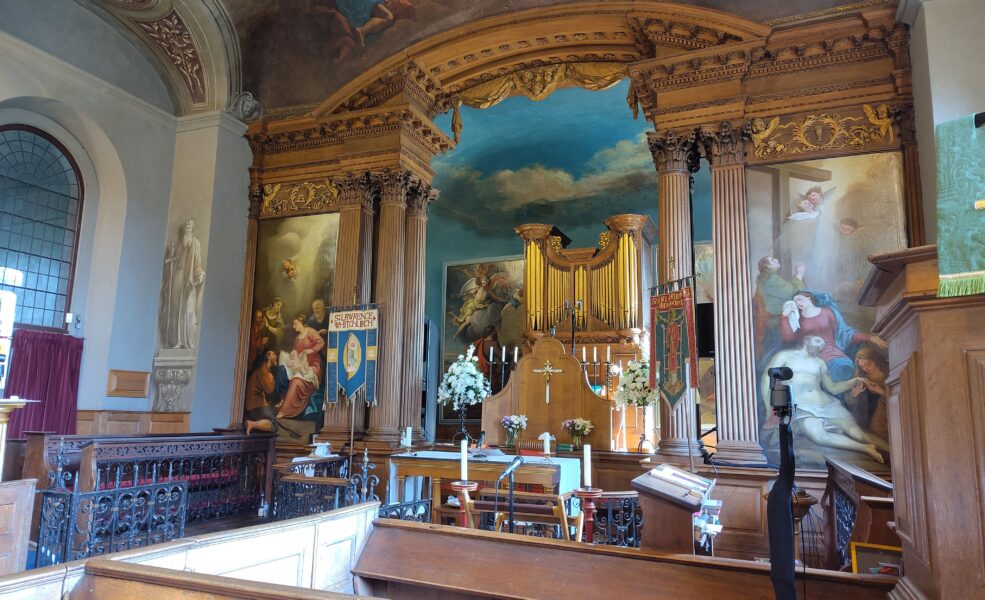 East end of Baroque church with wall paintings and elaborately carved organ East end of Baroque church with wall paintings and elaborately carved organ