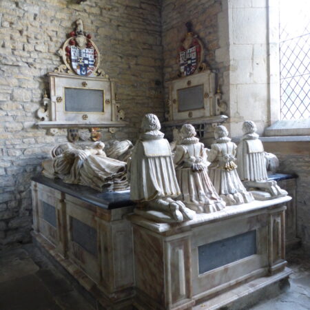 Chest tomb, recumbent effigies, life-size kneeling figures at feet