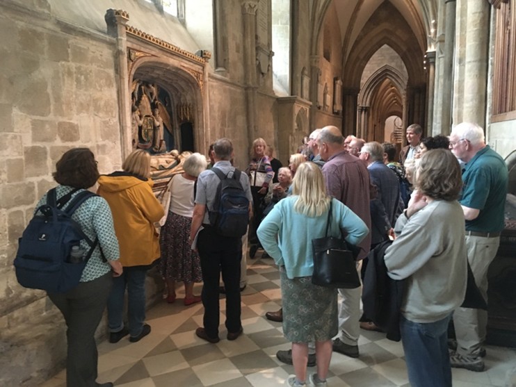 Group of people looking at a tomb