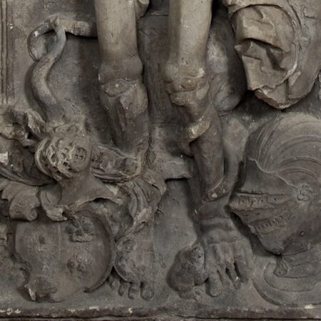 Lower legs and feet of cadaver effigy showing toad