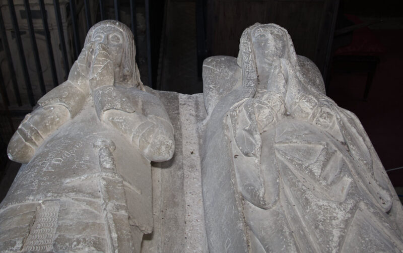 Effigies of male and female in early C16 costume: more detail in text