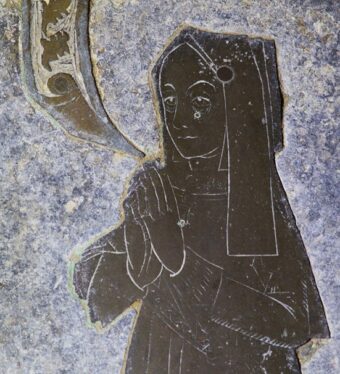 Detail of monumental brass showing upper part of female figure in English hood with long lappets