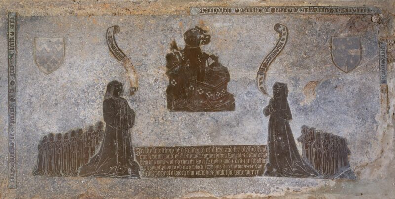 Monumental brass: couple on either side of depiction of the Resurrection, children behind them. More detail in text of artilcle.