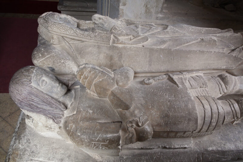 pper part of double effigy. She wears English hood with long lappets; he wears early C16 armour.