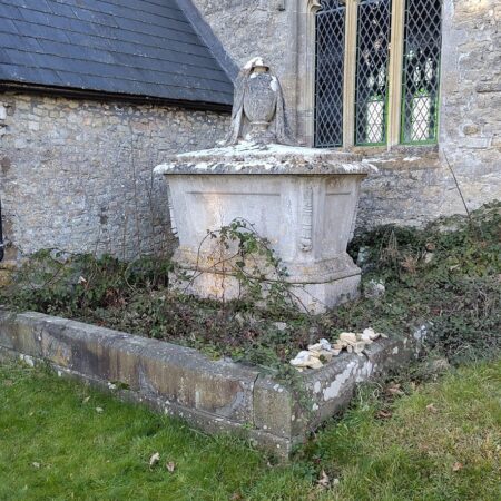 Exterior of church with chest tomb and plinth covering vault