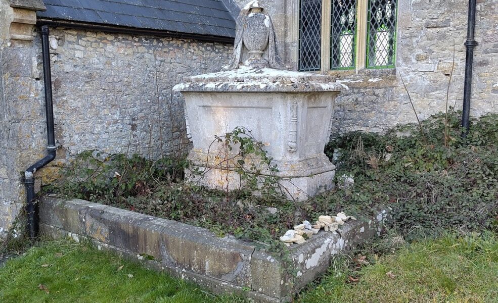 Exterior of church with chest tomb and plinth covering vault