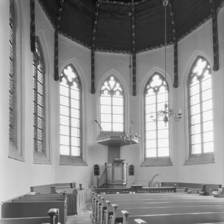 Apsidal interior of church, showing ledgerstones in floor between pews