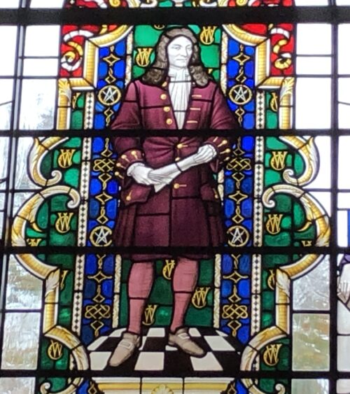 Stained glass window depicting Sir Christopher Wren holding rolled-up plans