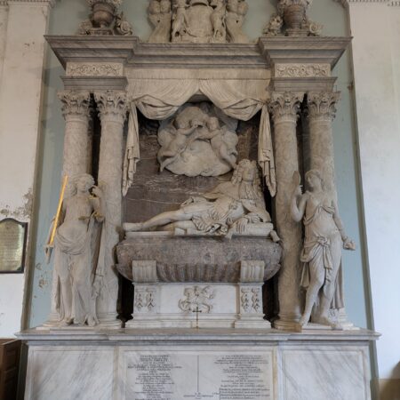 Reclining figure in semi-Roman costume, flanked by classical virtues and surmounted by putti