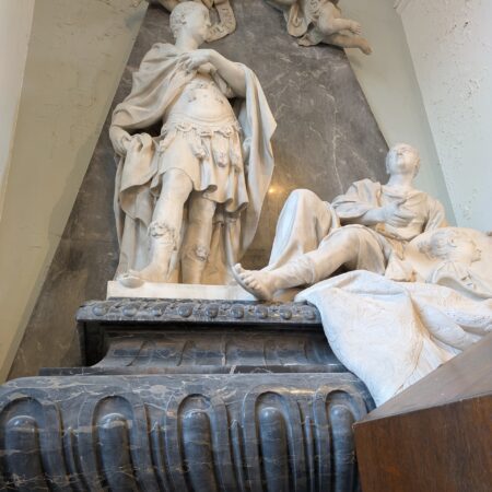 Standing figure in semi-Roman costume, reclining figure in drapery, cherubs overhead