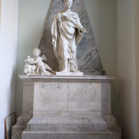 Standing figure in draped cloak (not quite a toga) flanked by cherub holding ducal coronet