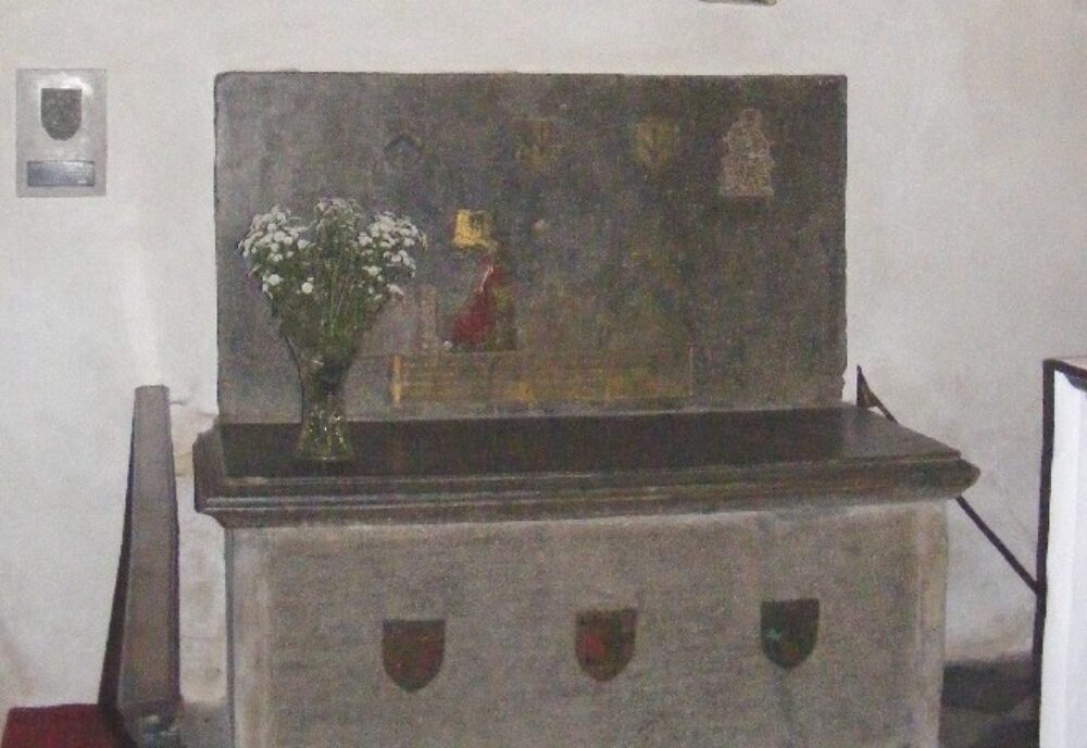 Monumental brass above tomb chest