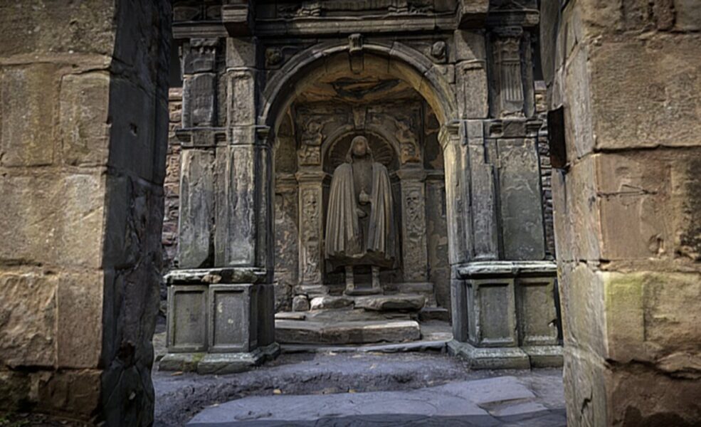 Statue of man in C17 legal dress standing under the arch of a classically-styled mausoleum