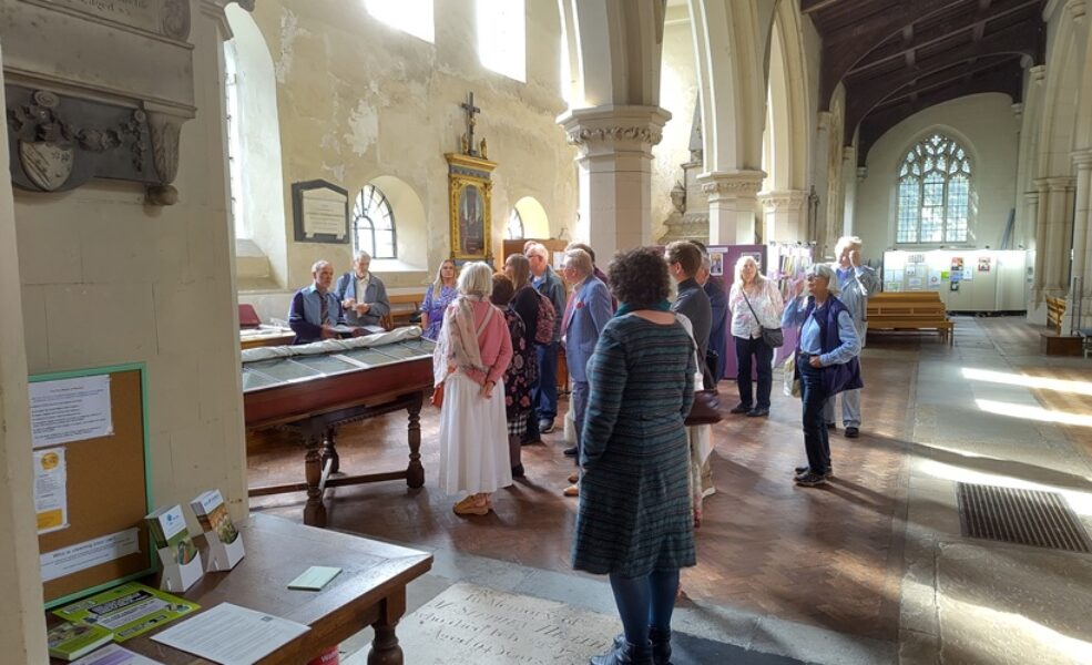 Group looking at monuments on south wall of church